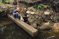 Ralph Lovern, Chesterfield County utility worker and amateur archaeologist, and timber from eighteenth-century Falling Creek ironworks.