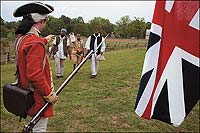 Left to right, Jason Gordon, Richard Josey, with a copy of Dunmore's proclamation, and Willie Wright approach a redcoat, here Stuart Pittman, to join the British forces and gain freedom.