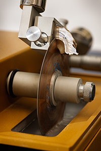 Oyster-shell specimens are sectioned by a 
spinning blade, allowing anthropologists to examine details on 
a microscope slide.