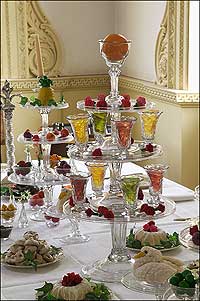 The table is set with finery and a colorful array of sweets for a reception at the Palace.