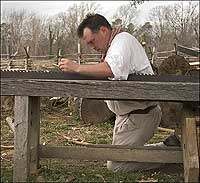 Carpenter Will Gore sharpens a pit saw for cutting timber into lumber.