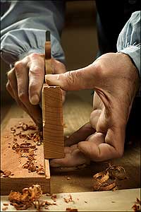 Cabinetmaker Mack Headley takes a plane to a board.