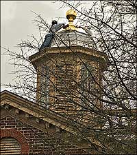 Installing a finial on the cupola