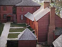 Reconstructed kitchen of the Peyton Randolph House, its central chimney rising from the hearth.