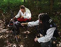 Boiled boot leather being eaten by Calvin Jenkins, left, and Patrick Strawderman when better sources of food had vanished.