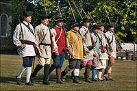 Dale Smoot, Josh Bucchioni, Chris Geist, Terry Yemm are among the militia interpreters parading across Market Square with their Magazine weapons.