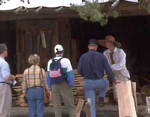 Rural tradesman Wayne Randolph and his colleagues take an informal approach to conversations with Colonial Williamsburg visitors who pause to chat about colonial agriculture and the like