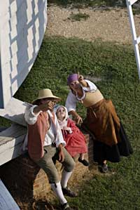 Nielsen and rural tradesperson Ramona Vogel point out to costumed little Molly Carr, the daughter of interpreter Lyndon Howlett, how the vanes spin.