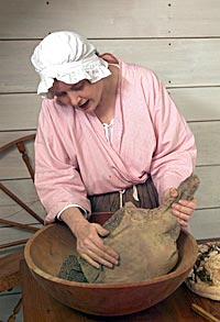 At the Randolph Kitchen, Barbara Ball prepares a ham to smoke.