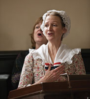 Interpreter Jane Hanson closes the ceremony at the House of Burgesses with “America the Beautiful.”