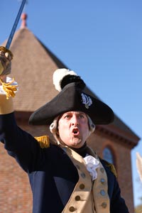 A major general in the Continental Army, Lafayette (Schneider) raises his sword to rally troops.