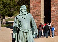 From the camera angle, the statue of John Smith appears to guard the entrance to the 1647 church.