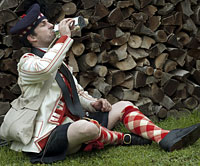 Randolph Davis, as a company drummer of the 71st Regiment (Fraser’s) Highlanders, circa 1780, takes a swig of grog.