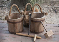 Tools of the maple syrup trade: an auger to bore a hole in the tree, a mallet to tap the wooden spile in, and buckets to collect the sap.