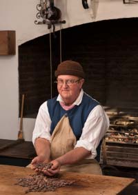 Jim Gay holding roasted cacao seeds in the Palace kitchen