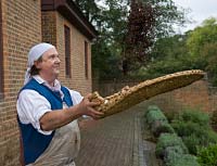 Jim Gay uses a winnowing basket to free the seeds from the chaff.